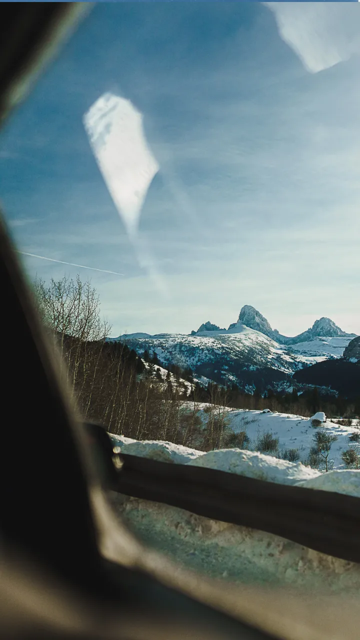 A view of mountains through a car window