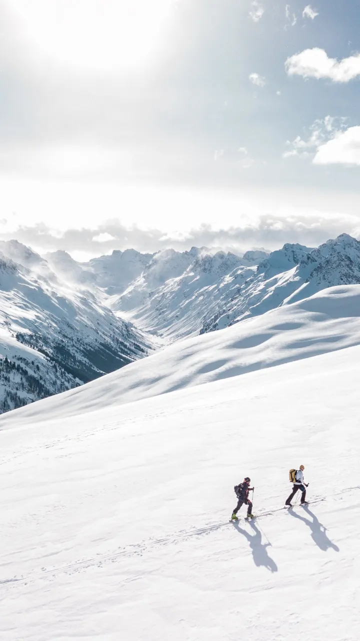 Two backcountry skiers touring in the mountains