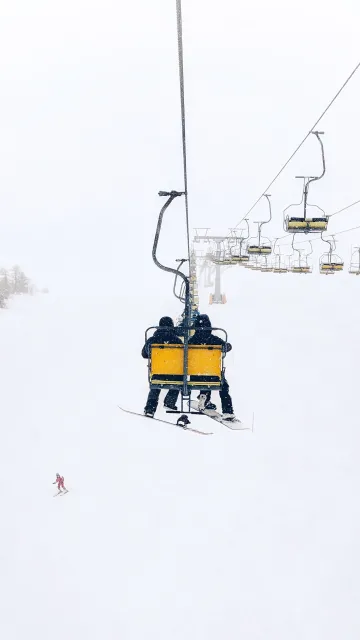 Two people going up a chairlift