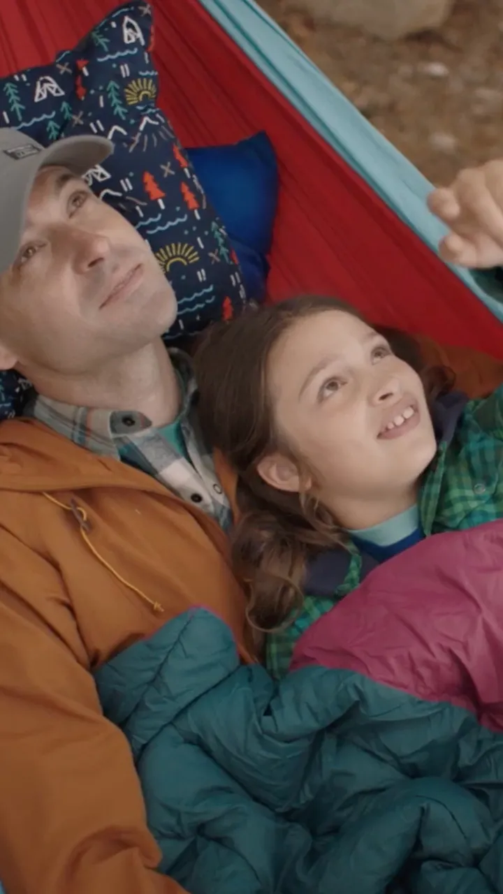 Father and daughter swinging in a hammock