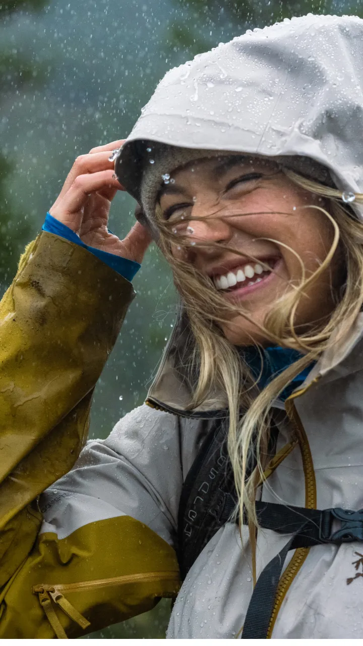 A woman laughing in the rain