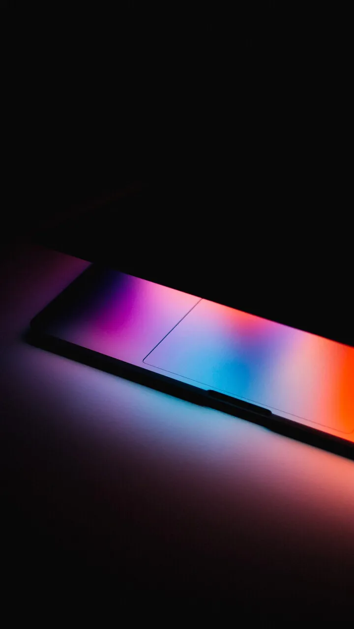Laptop screen glowing in the dark