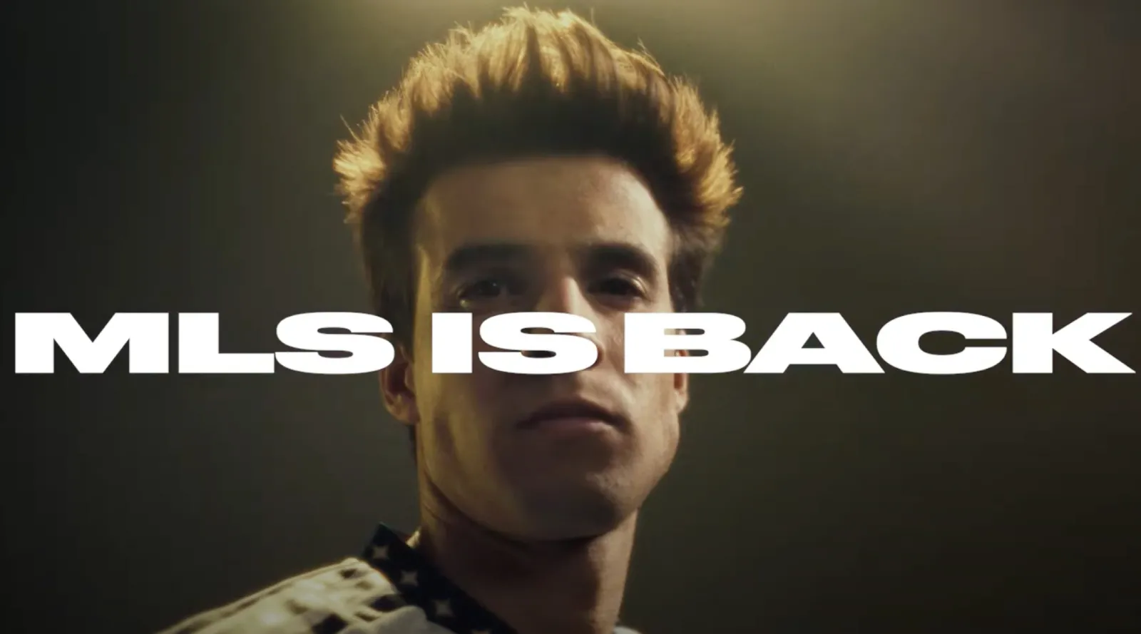 Dramatic soccer player's face behind 'MLS IS BACK'