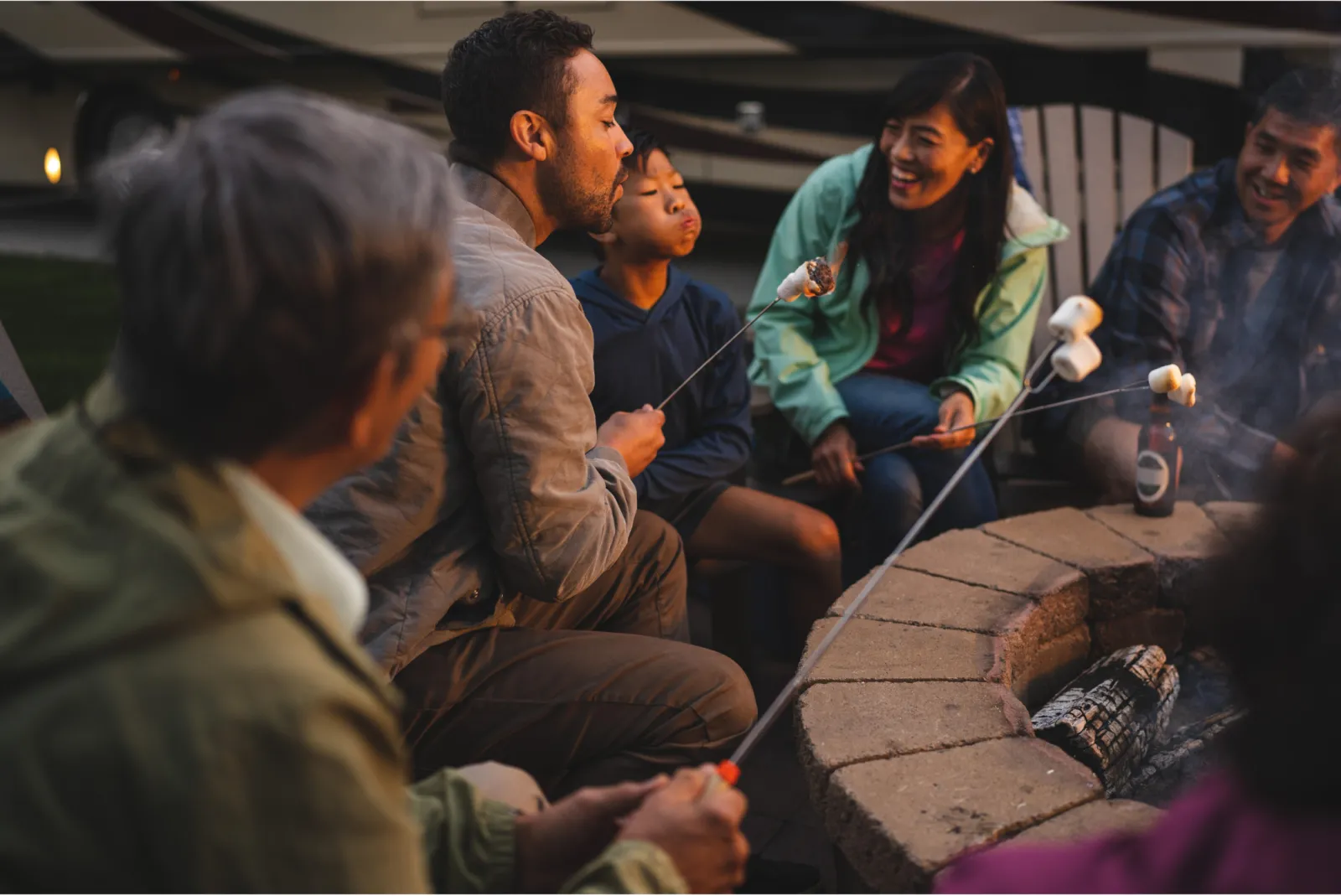 A family toasting marshmallows round a fire