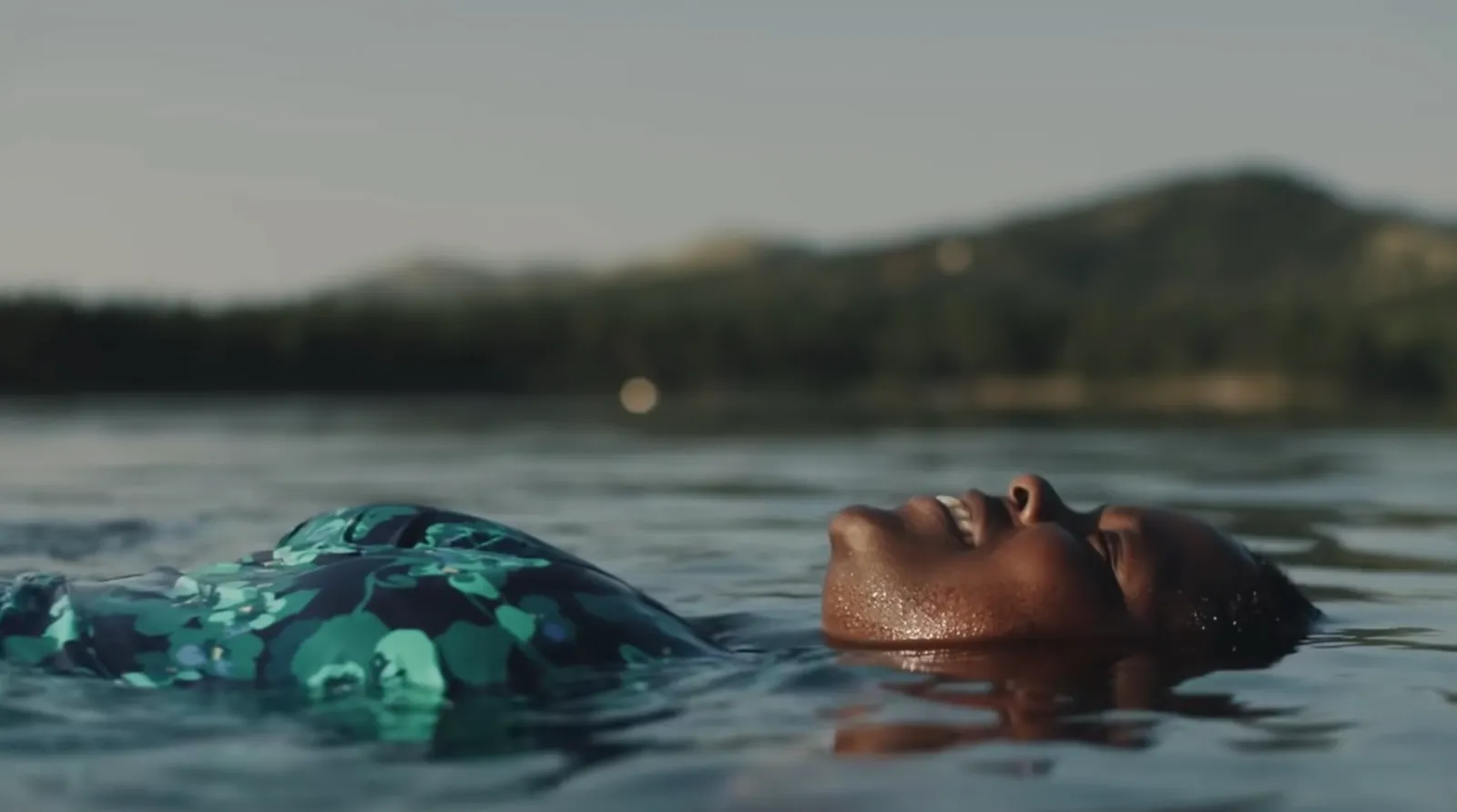 Women floating on her back in a lake