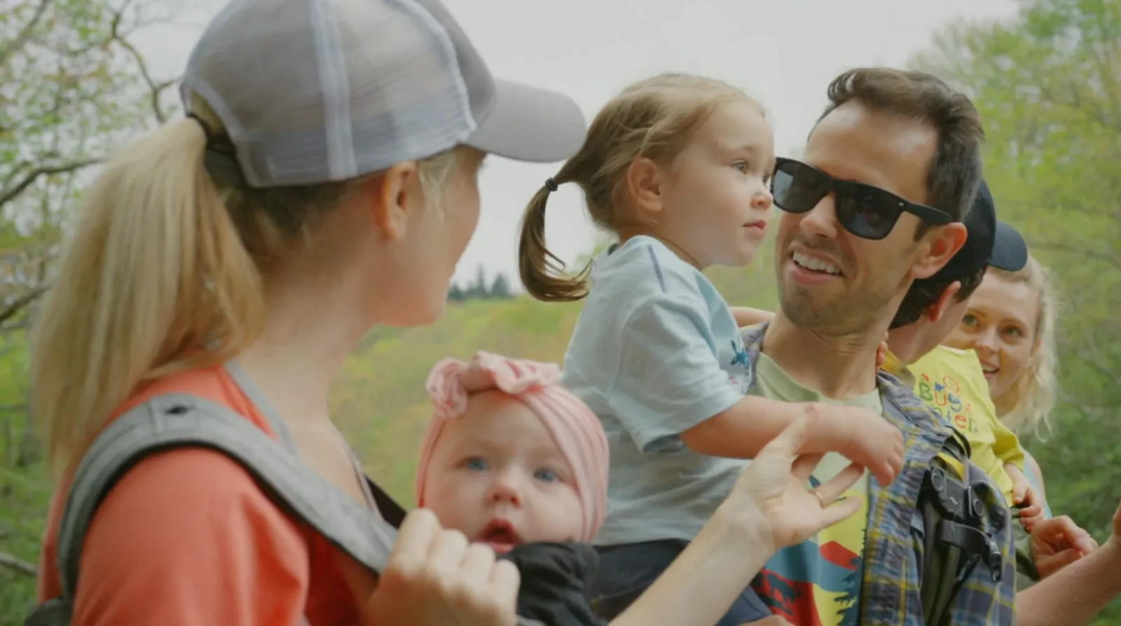 Parents and toddlers prepping for a hike