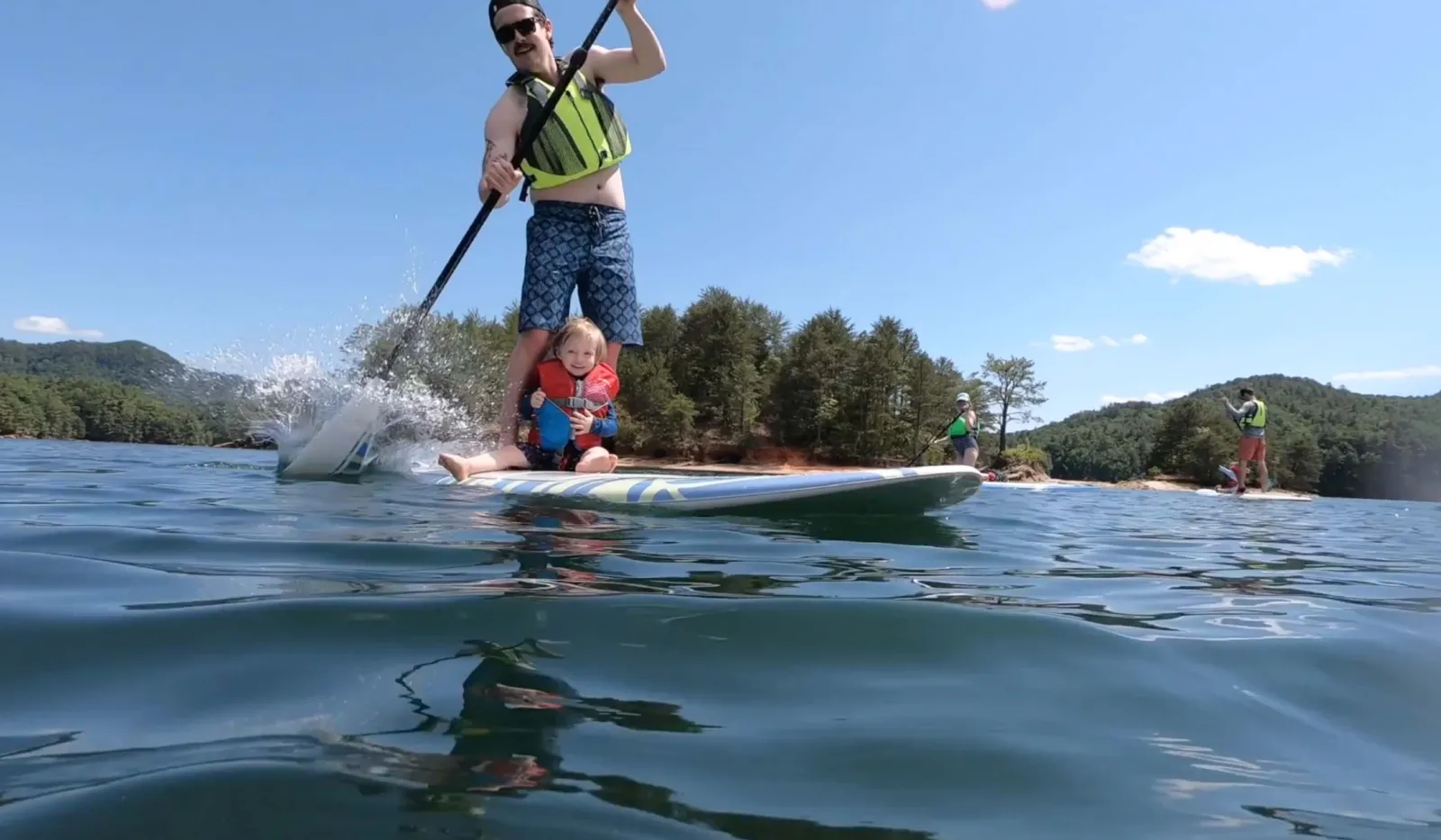 Father and son paddle boarding
