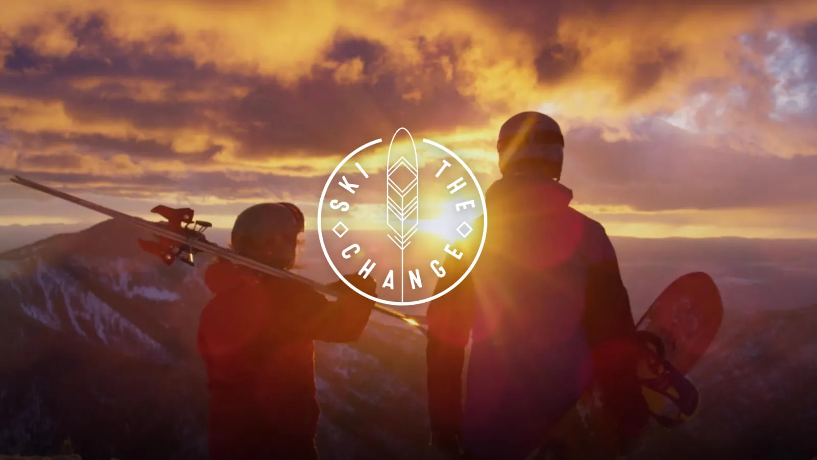 Ski the Change logo and image of 2 skiers looking at the sunset