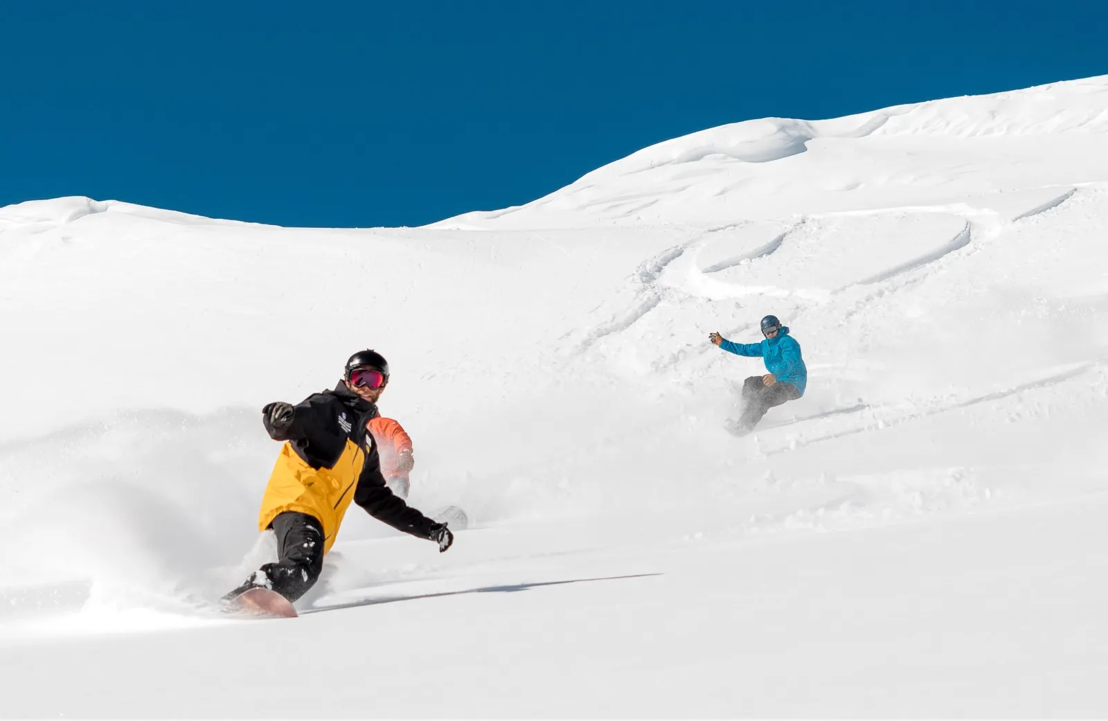 people riding down a slope