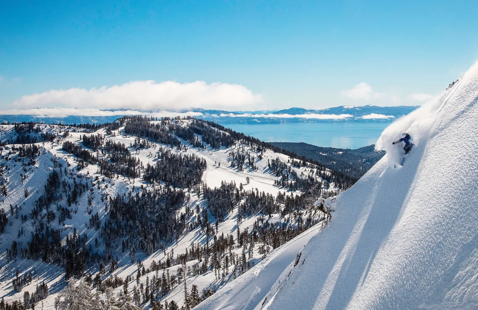 Skier with lake and mountains in the background