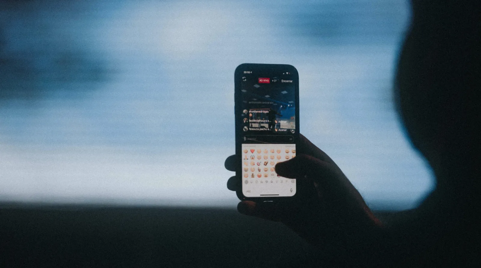 Person holding up an iPhone with TikTok on the screen