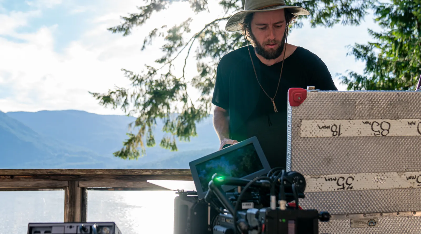 Cinematographer reviewing their gear in on a sunny deck