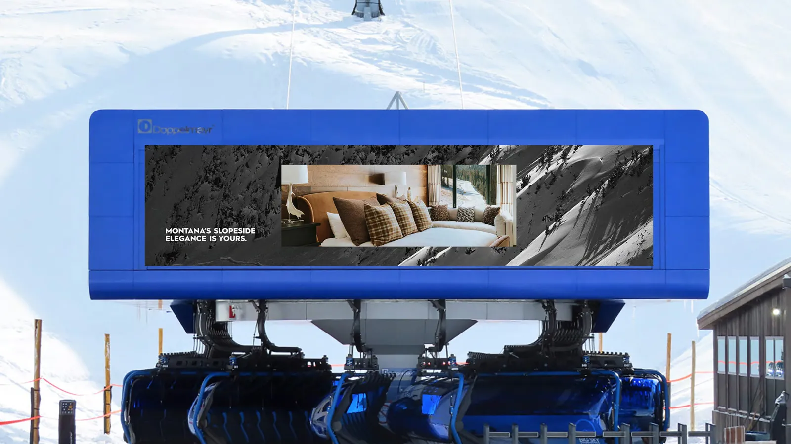 Blue ski lift station against snowy mountain backdrop.