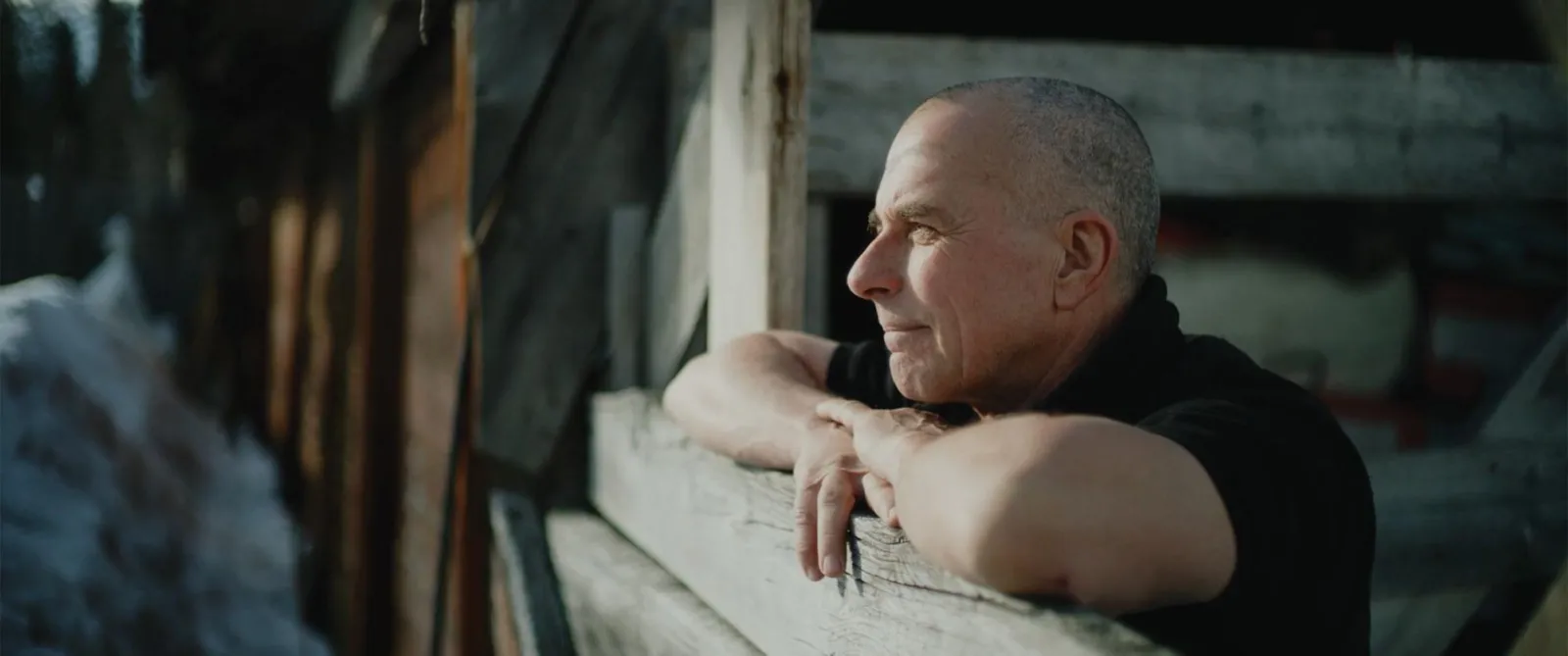 A man looks out from a ranch