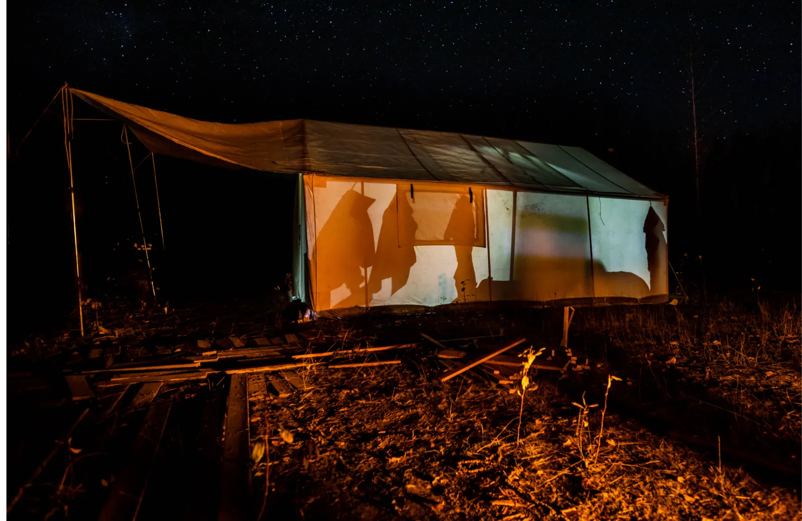 Canvas camping tent at night under stars