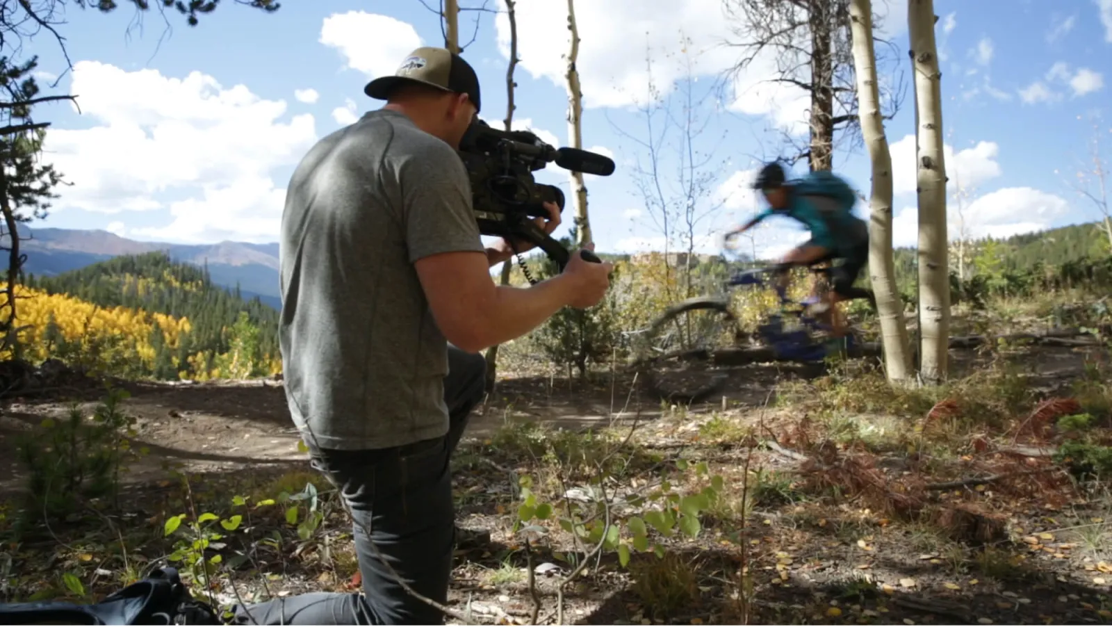 Biker riding with a camera man filming them
