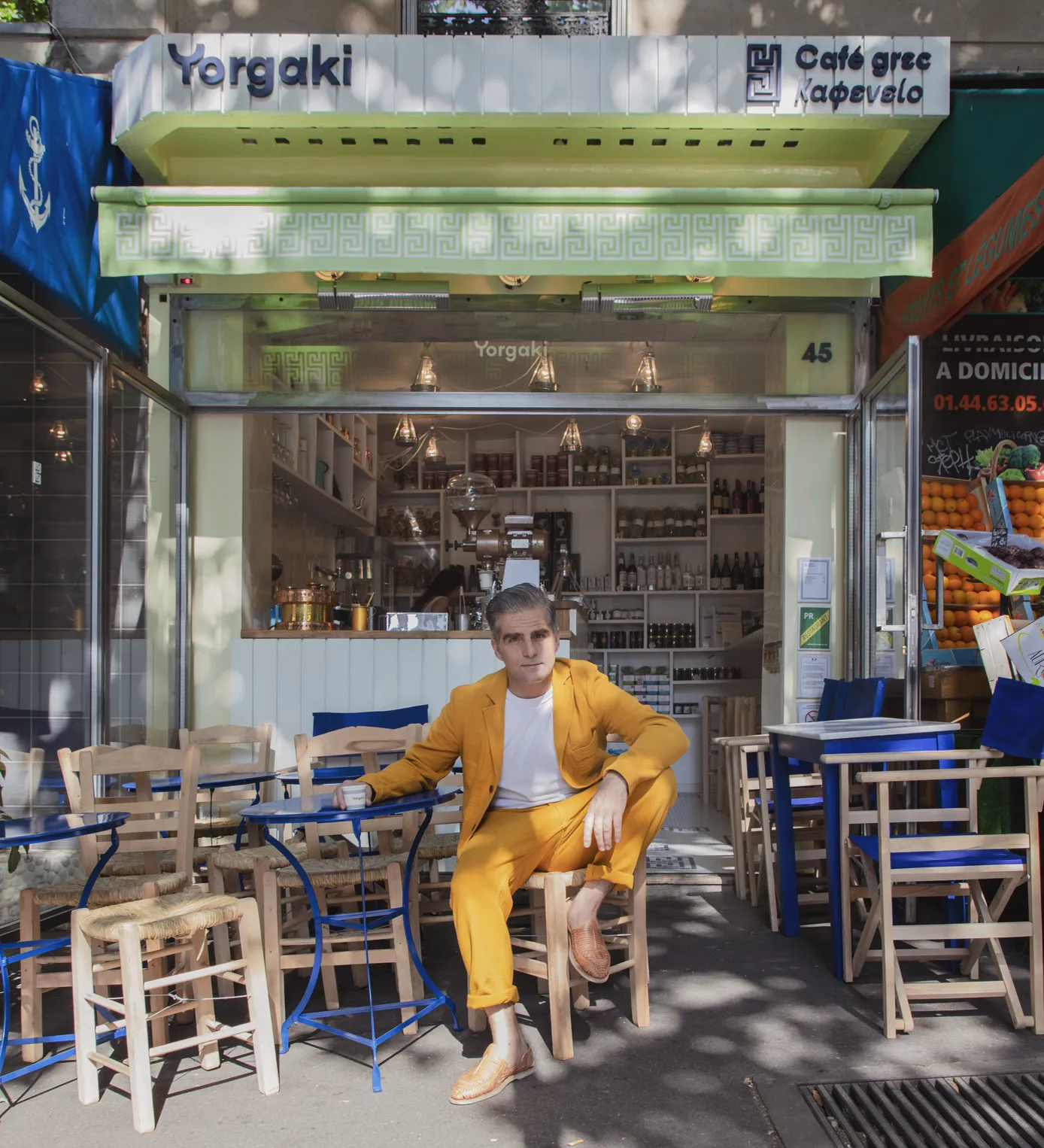 Yorgo posing in front of his freshly minted cafe. 
