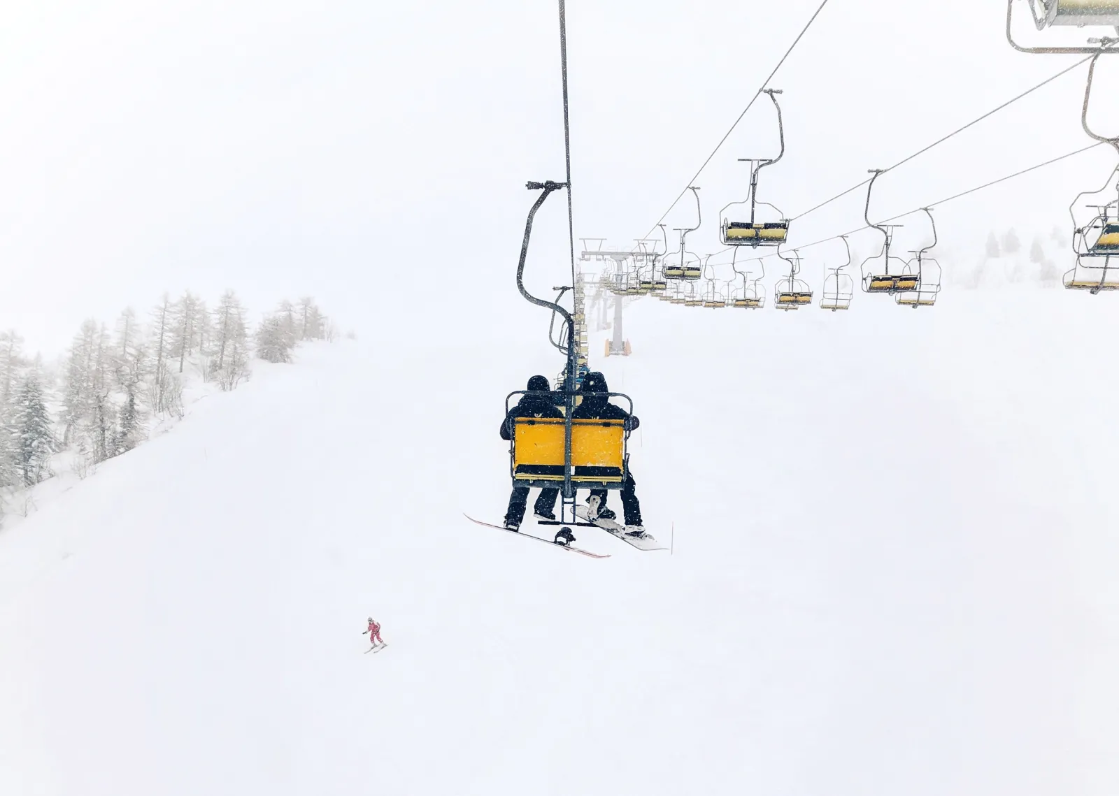 Two people going up a chairlift