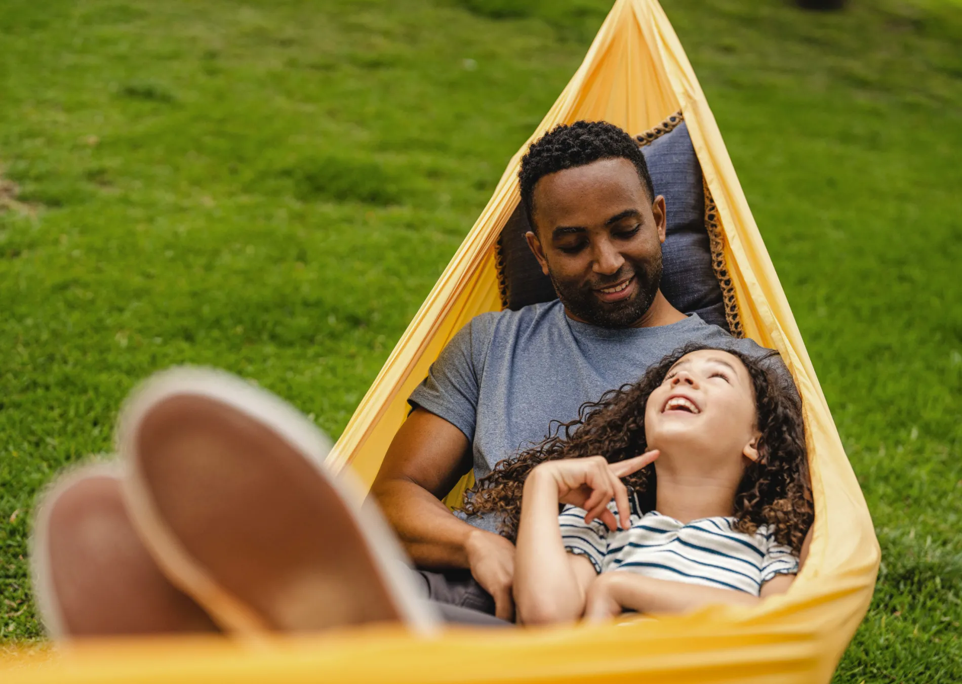 A dad and daughter in a hammock