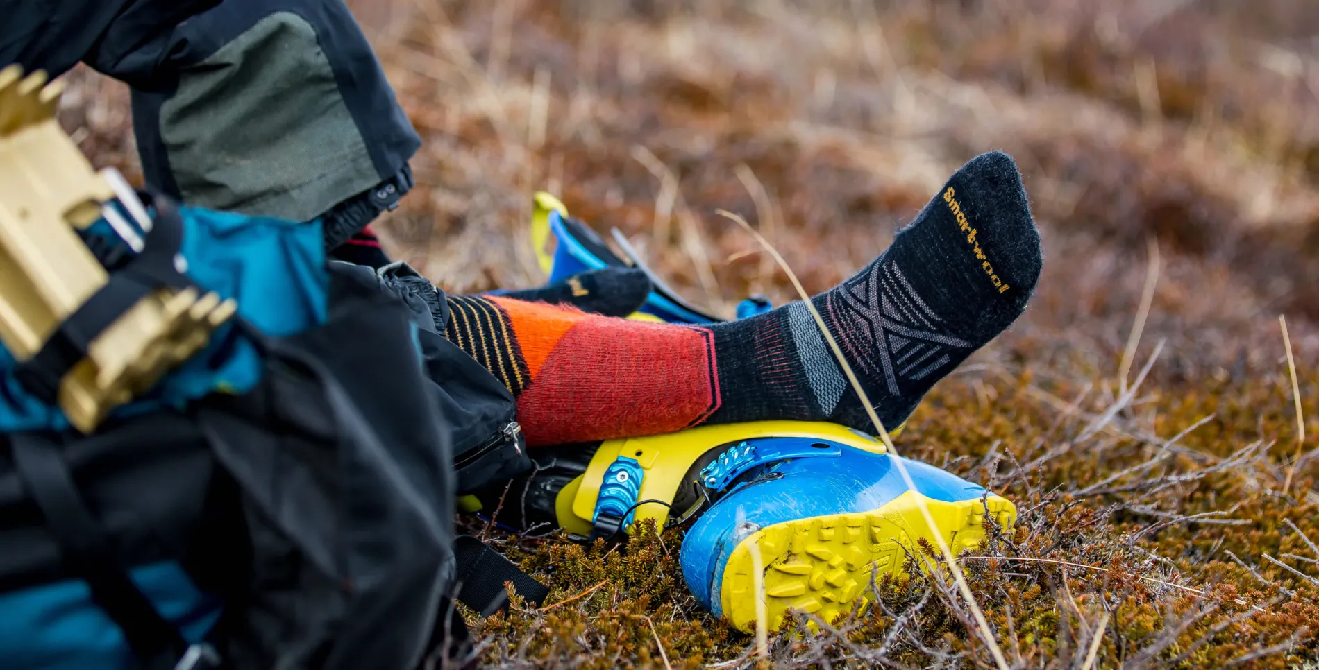 Person putting on smartwool socks in the backcountry