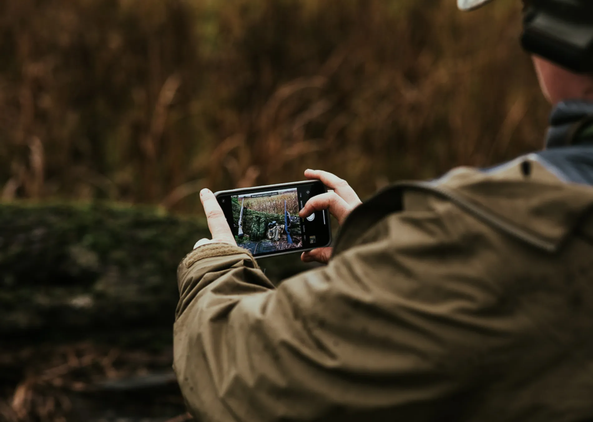 A close up of someone taking a photo with an iPhone