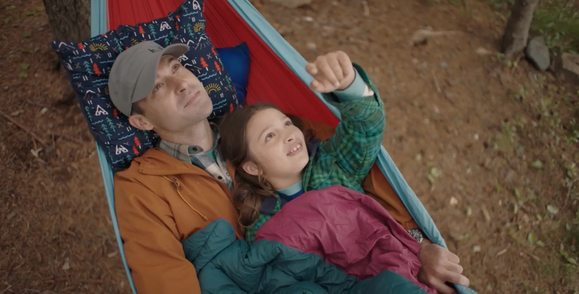 Father and daughter swinging in a hammock