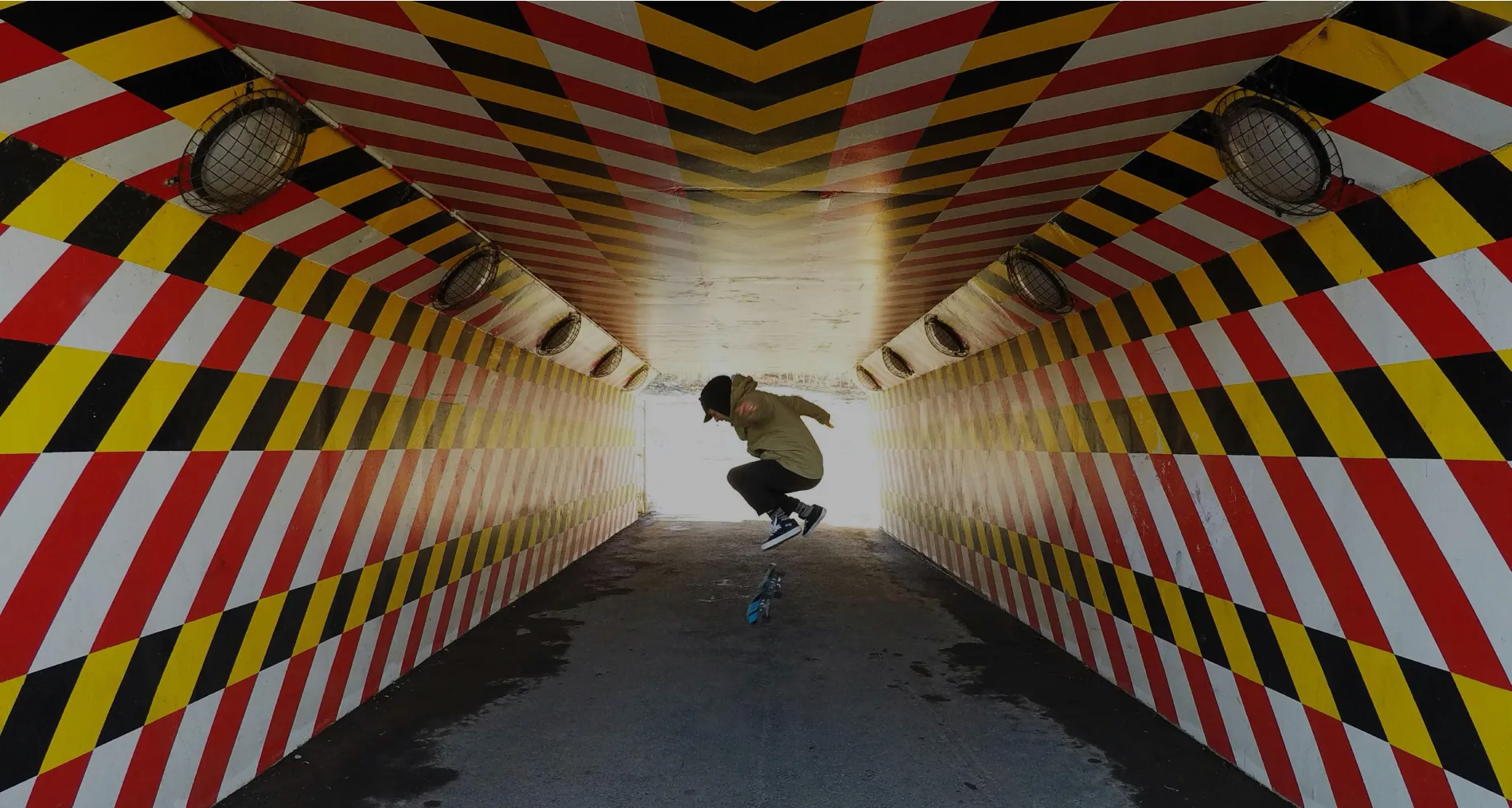 Skate boarding through a tunnel