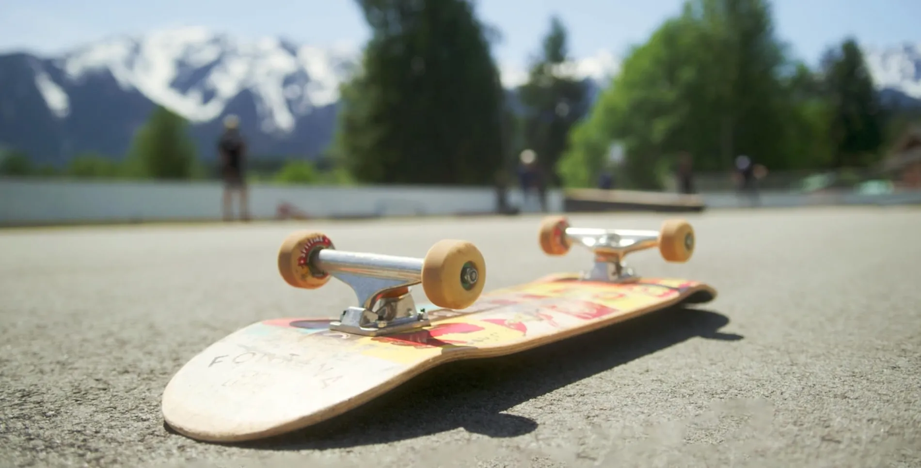 Skate board on ground with mountains in the background