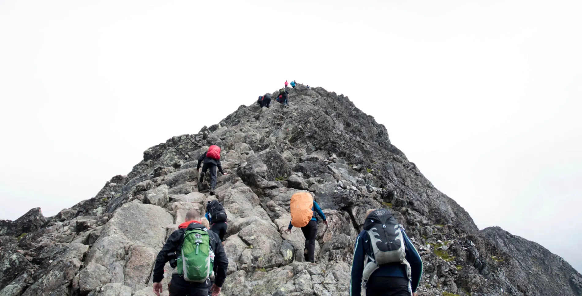 group of people hiking up a mountain