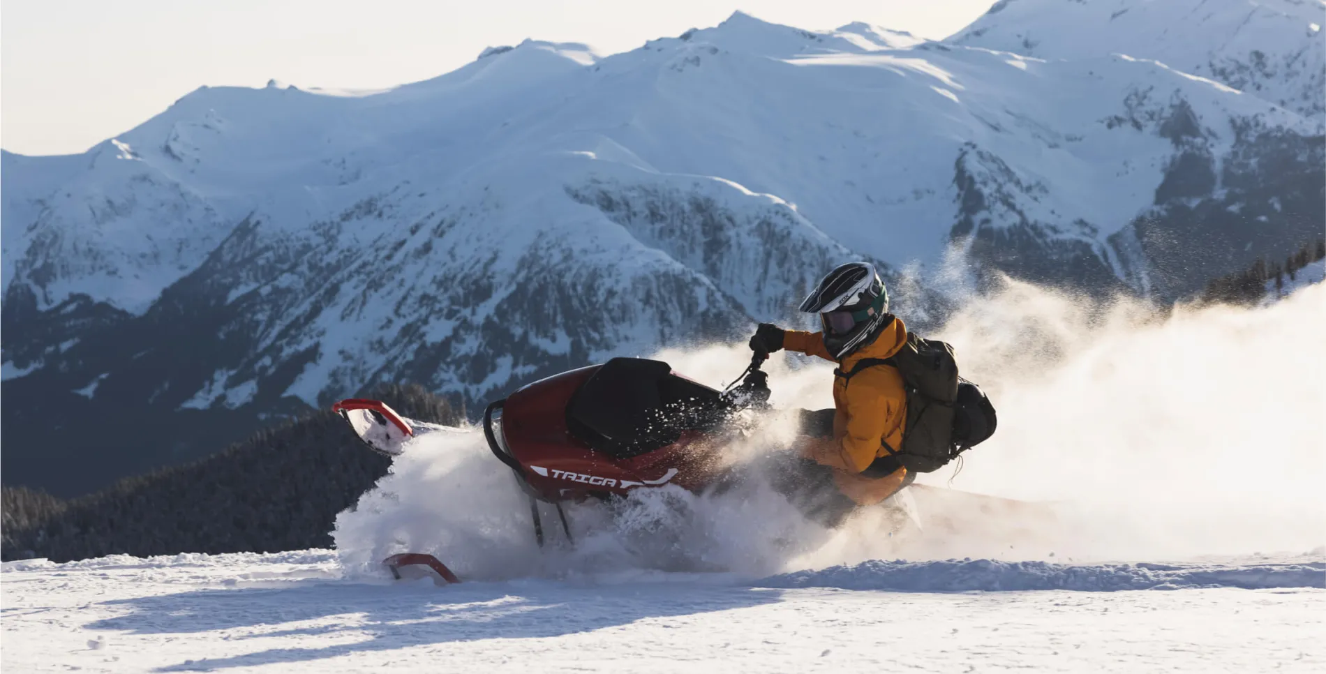Taiga snowmobile plowing through snow