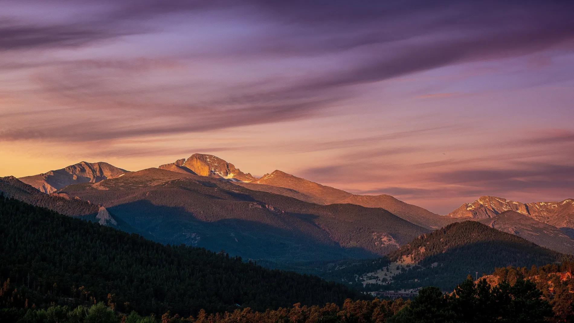 Mountain landscape under a vibrant sunset sky.